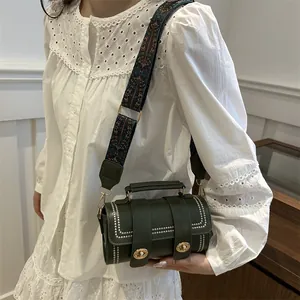 Retro dark green leather baguette bag with silver studs and wide jacquard shoulder strap