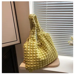 Detailed view of yellow bubble texture fabric on a summer shoulder tote bag