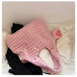 Detailed view of pink bubble textured fabric on a stylish large capacity tote bag