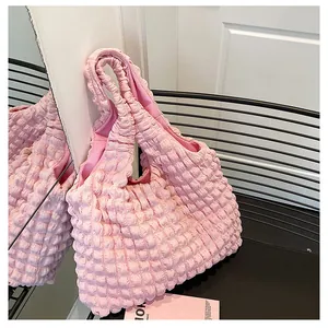 Detailed view of pink bubble texture fabric and interior lining of the fashion tote bag