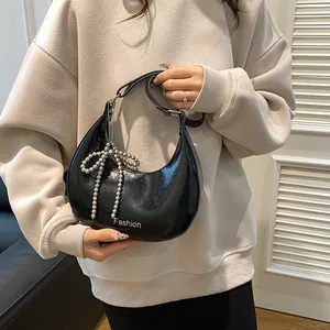 Retro black moon shoulder bag with glossy crinkle leather and silver bow pendant charm