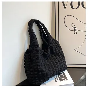 Close-up of the bubble textured fabric on this stylish black pleated tote bag