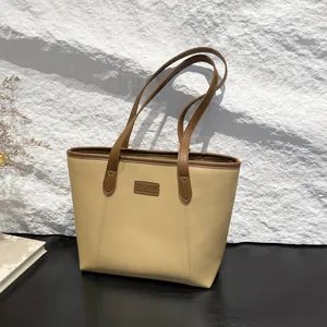 Retro faux leather tote bag in beige and dark brown with long handles for shoulder wear