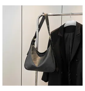 Detailed view of black cracked leather hobo bag with vintage texture and gold hardware