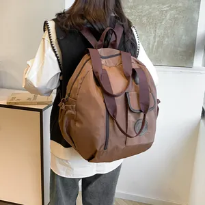 Brown nylon large travel backpack shown from a side angle on person for daily use