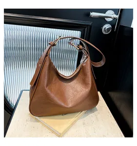 Detail view of caramel brown hobo bag with vintage pleated leather and wide strap