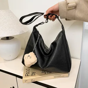 Large black leather tote bag with silver chain and cute teddy bear charm for women