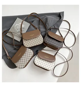 Detail shot of four vintage crossbody bags with classic monogram texture and leather straps