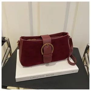 Détail du sac à bandoulière bordeaux givré avec une boucle dorée vintage