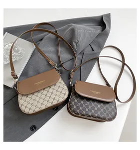 Detail of vintage monogram flap bags with adjustable straps and golden logo lettering