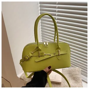 Detailweergave van de avocadogroene PU-leren tas met gouden gesp en gladde matte textuur
