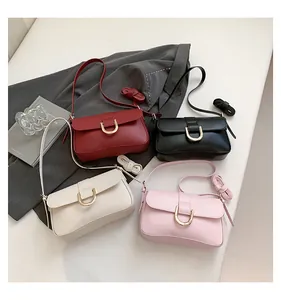Detailed display of minimalist handbags in black, red, cream, and pink with gold U-buckles