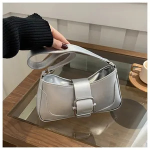 Detailed view of a silver metallic hobo bag with an elegant square buckle closure