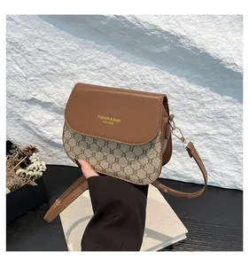 Close-up of contrast checkered small square bag with luxury gold embossed lettering