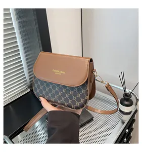 Detail of vintage saddle bag with brown leather and jacquard canvas texture