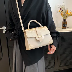 Elegant cream crocodile pattern leather handbag with adjustable crossbody strap for women