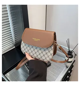 Close-up of contrast checkered small flap bag with golden logo and premium leather texture