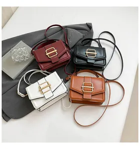 Detail view of four elegant crossbody bags in burgundy, black, white, and brown with gold buckles