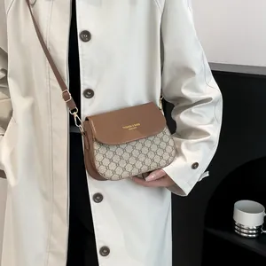 Classic brown checkered crossbody bag with adjustable strap and golden logo detail
