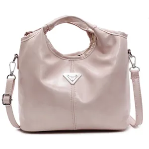 Elegant pink glossy faux leather tote bag with silver logo and adjustable shoulder strap