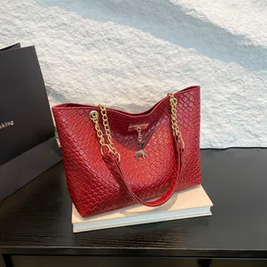 Deep red woven tote bag with gold deer charm and chain strap for women commuting