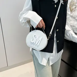 White semi-circular leather crossbody bag with SM embossed letters and gold hardware