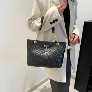 Fashionable black woven tote bag with gold chain strap and deer pendant for women