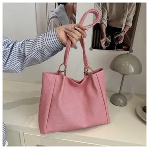 Close-up of pink striped tote bag showing woven fabric texture and gold metal ring detail