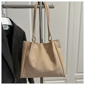 Detailed close-up of woven texture and metal ring connection on a beige tote bag