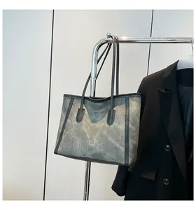 Large capacity vintage contrast tote bag with marble texture hung on a metal rack