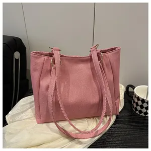 Close-up of pink striped canvas tote bag with gold metal rings and fabric straps