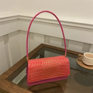 Sac à bandoulière rose fuchsia gaufré crocodile avec détails dorés et poignée chic