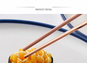 Detail of rose gold Korean flat chopsticks picking up sushi from a ceramic plate