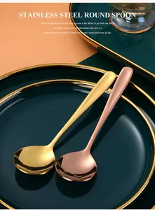 Detail of round stainless steel spoons in gold and rose gold with mirror polish