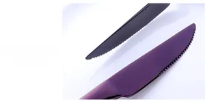 Macro shot of sharp serrated edge on purple and gunmetal stainless steel steak knives