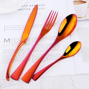 Rainbow gradient stainless steel 4-piece cutlery set on marble surface backdrop