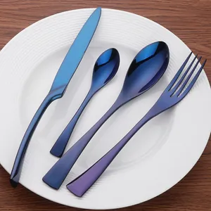 Modern 4-piece stainless steel cutlery set in deep blue finish on white porcelain plate