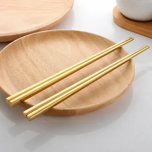 Close-up of golden hollow 304 stainless steel chopsticks with square anti-roll design