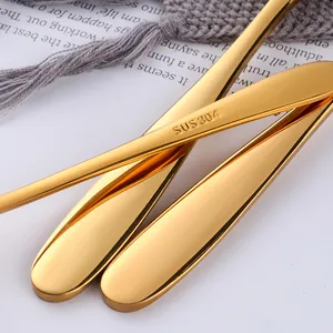 Polished gold 304 stainless steel cutlery set shown on a modern lifestyle background