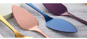 Close-up of multicolored mirror polished stainless steel cake servers with serrated edges