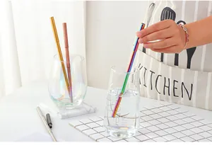 Detail of colorful 304 stainless steel telescopic straws in a glass with metallic finish