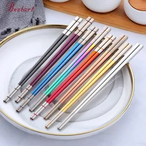 Close-up of high-quality colorful 304 stainless steel chopsticks set on a white ceramic plate