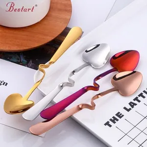 Macro detail of heart-shaped stainless steel spoons with curved handles for cup hanging
