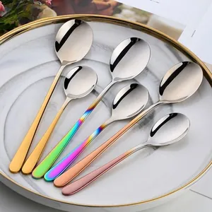 Polished 304 stainless steel spoons in various colors displayed on a white plate