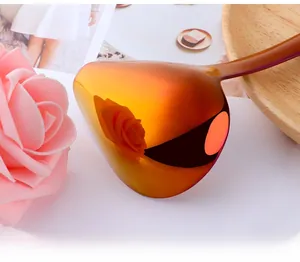 Macro shot of mirror-polished gold stainless steel spoon with sleek handle detail