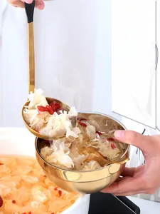 Close-up of double-layered insulated stainless steel soup bowl and gold spoon in use