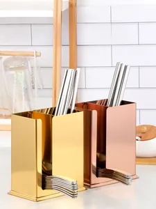 Dual-slot stainless steel holder in gold and rose gold for organized cutlery storage