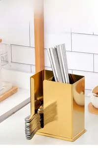 Detail of golden stainless steel cutlery holder with double compartments and U-shaped opening