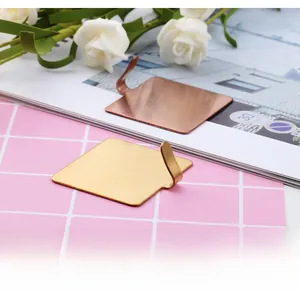 Detail of gold and rose gold stainless steel wall hooks with brushed metal finish