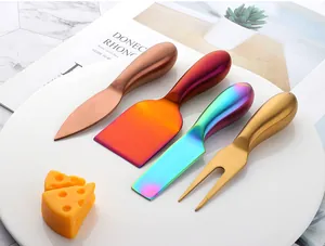Close-up of a 4-piece colorful stainless steel cheese knife set on a white plate